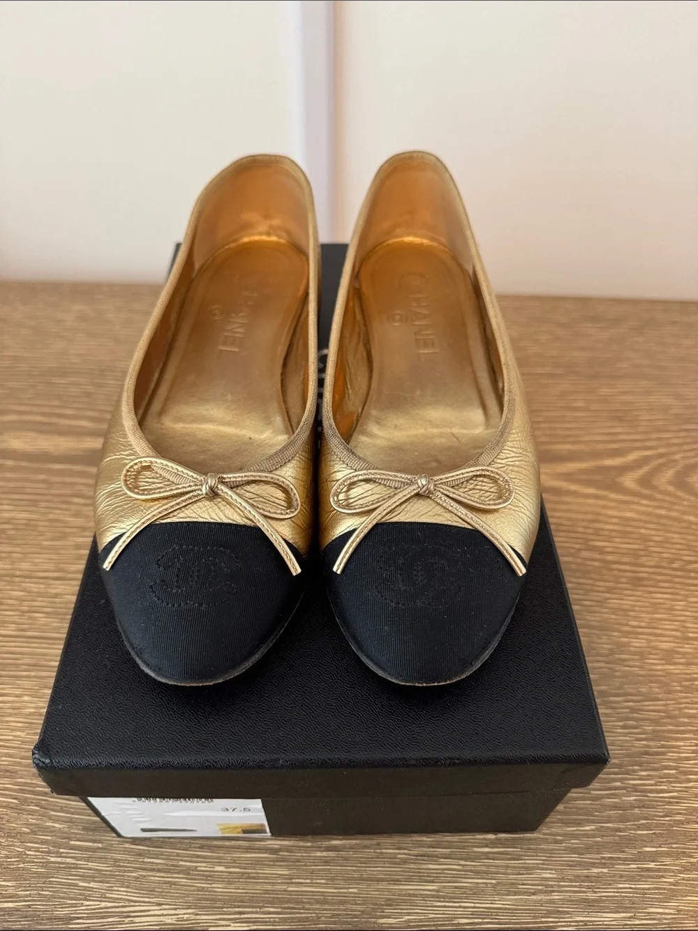 CHANEL Gold Leather Ballet Flats with Black Cap-Toe
